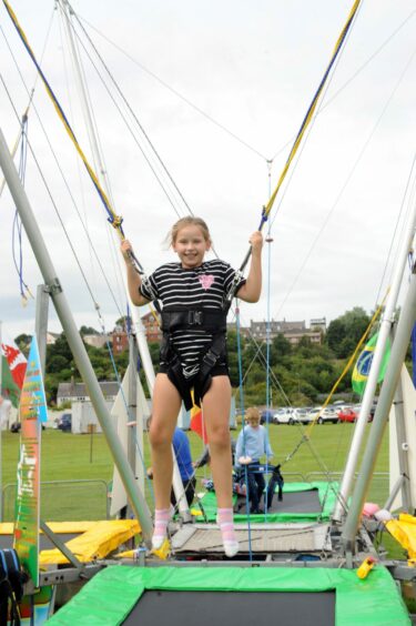 A youngster enjoying the trampoline at the Inverkeithing Highland Games 2023. 