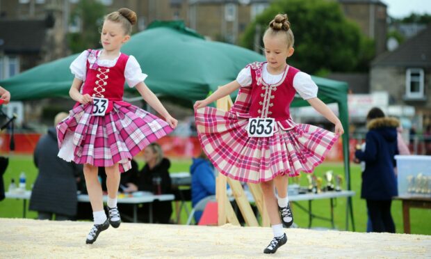 Highland dance duo perform on stage at the Inverkeithing Highland Games.