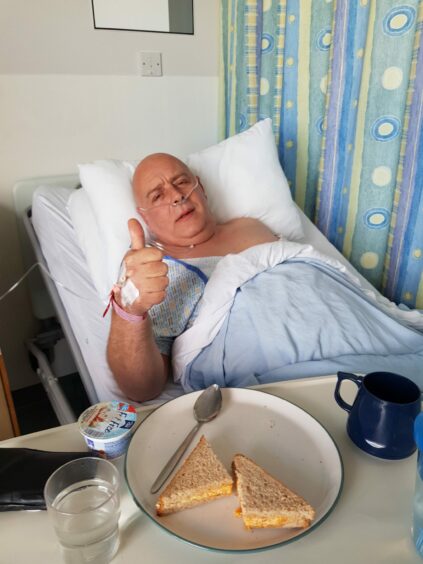 Carl Garner in hospital after the operation to remove a tumour on his bladder. 