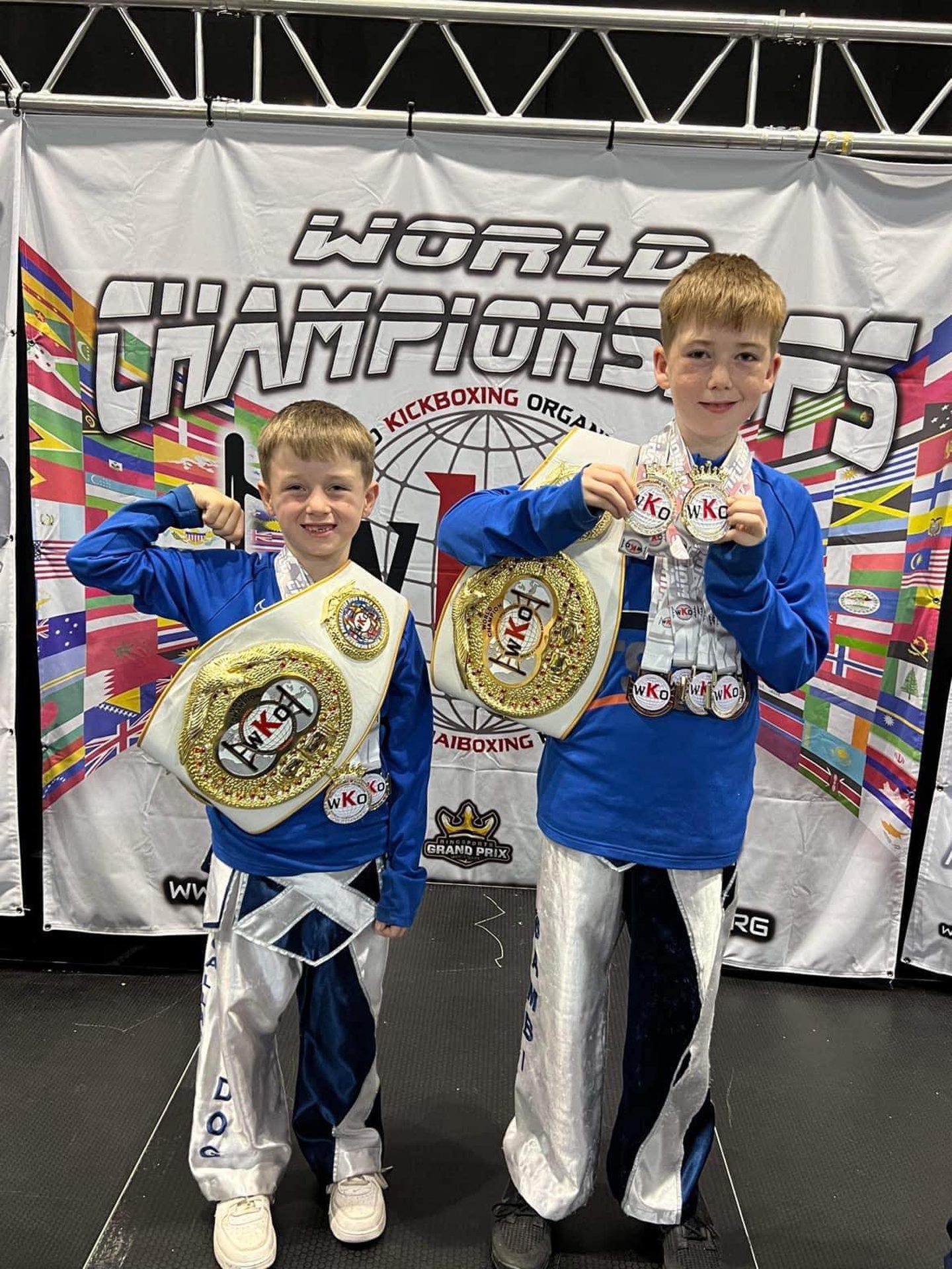 Chase and Rio with their medals and belts