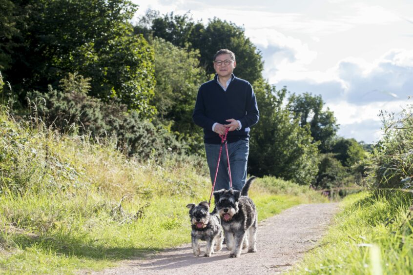 Professor Chim Lang with his two schnauzer dogs Bella and Bowie. 