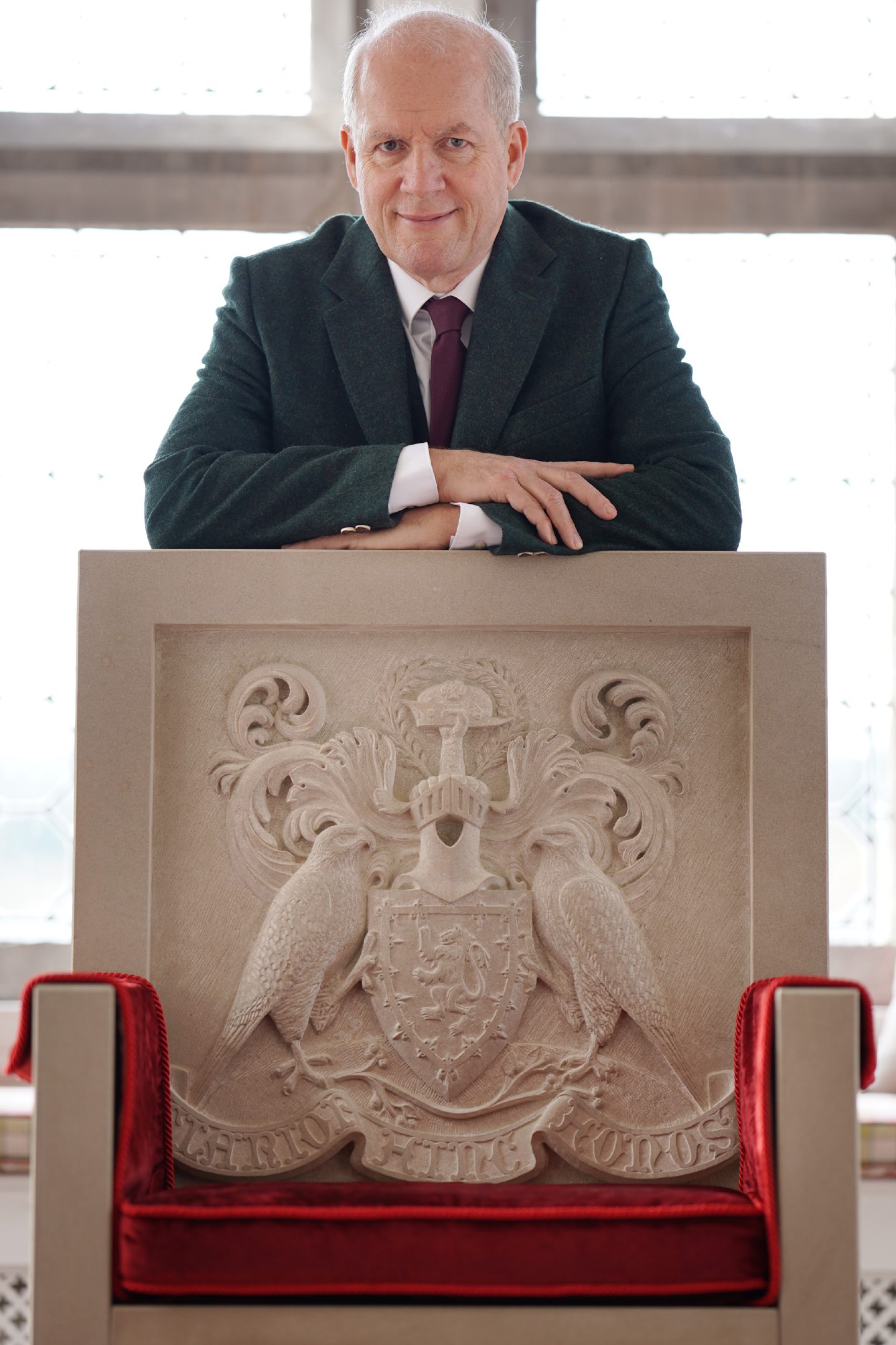 Mike Buchanan stands behind a throne. Image: Buchanan clan/Stewart Atwood Photography.