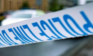 Police tape in front of a police car in Dundee