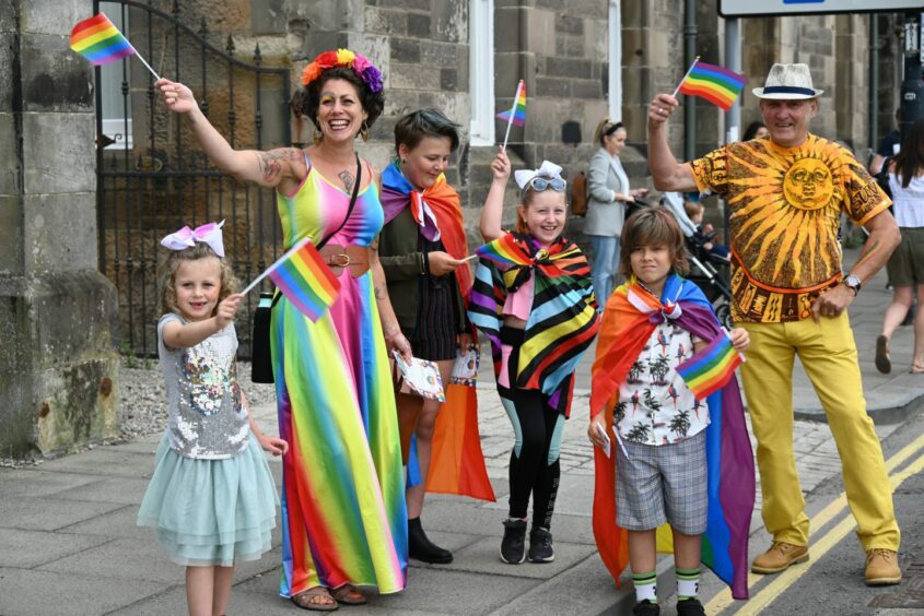 Woman and children in rainbow coloured clothes for Perthshire Pride.