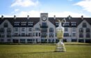 The famous claret jug in front of the distinctive Carnoustie Golf Hotel. Image: PA/TheOpen.com