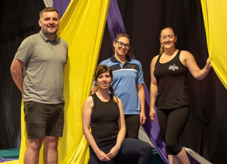 Logan McConachie, of Live Active; Roxanne Kerr of Trauma Healing Together; Gemma Simpson of Live Active, and Suzie Bee in sports gear against colourful banners.