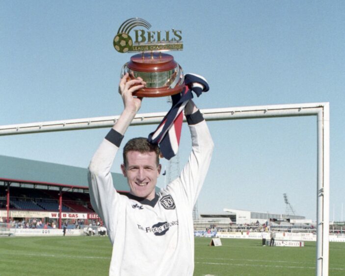 Dundee's Brian Irvine celebrates winning the First Division championship.