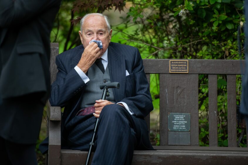 Mourner on a bench at Billy Boyle's funeral