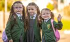 Gracie, Willow and Olivia Gordon on their first day at Craigowl Primary School. Image: Kim Cessford.