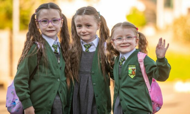 Gracie, Willow and Olivia Gordon on their first day at Craigowl Primary School. Image: Kim Cessford.