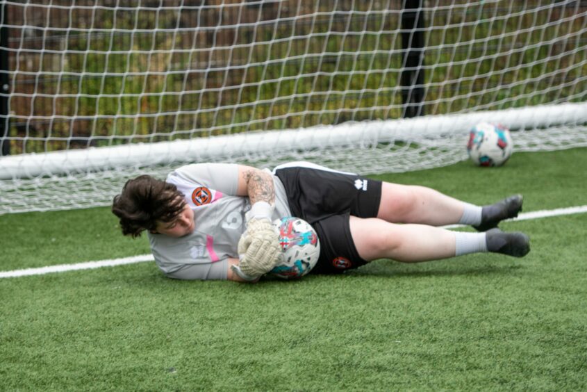 Dundee United keeper Lauren Sangster clutches a powerful low drive