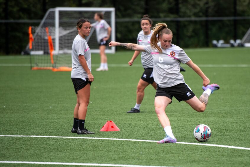 Dundee United women captain Rachel Todd shoots as Cassie Cowper looks on