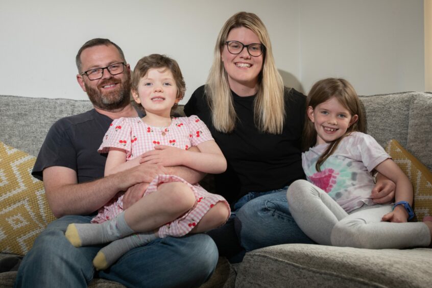 Erin pictured with dad Derek, mum Catrina and sister Neave, 8.