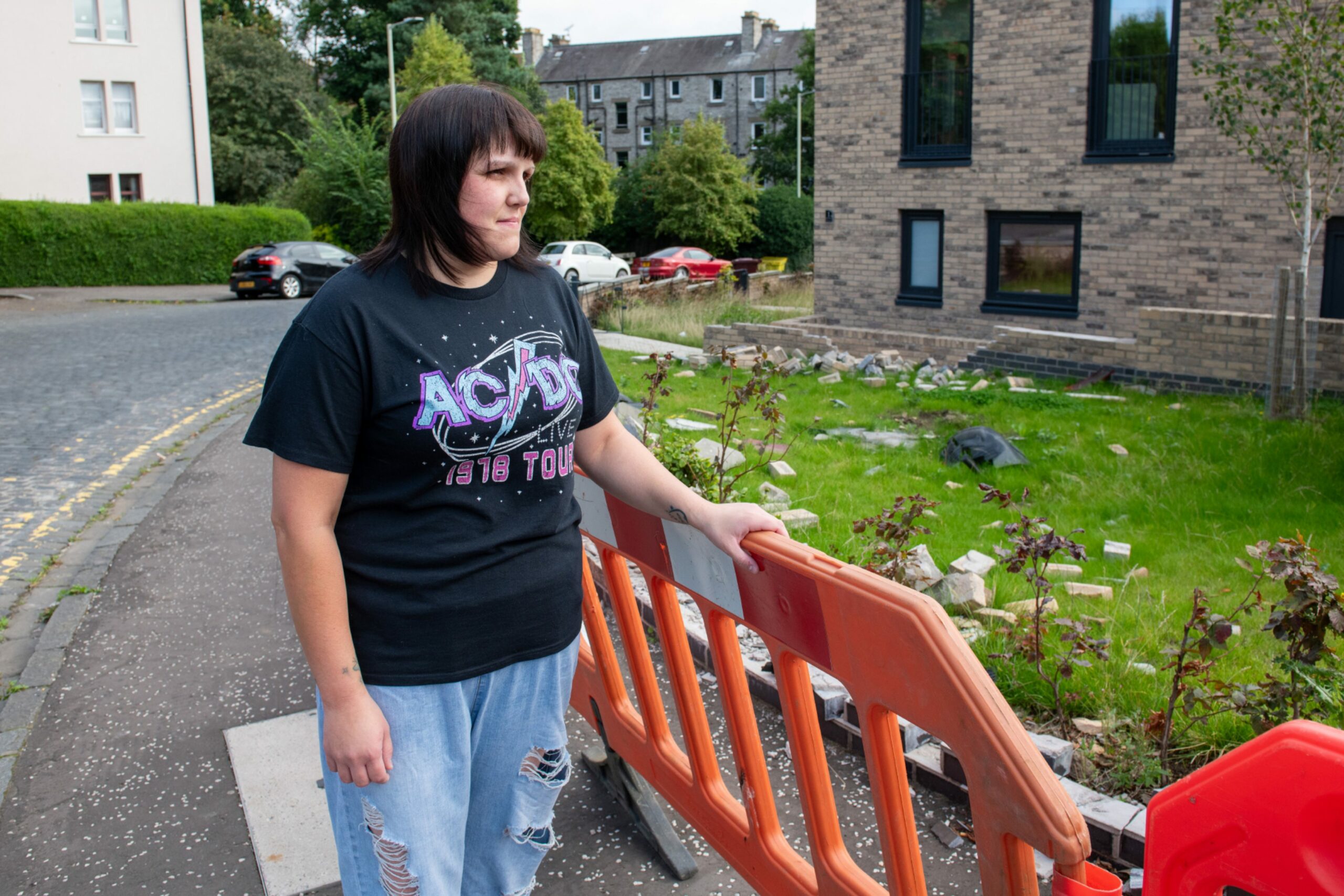 Sarah Ritchie with the damaged wall outside her Derby Street home