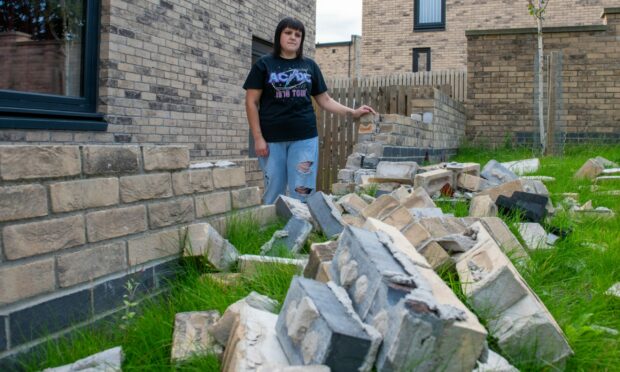 Sarah Ritchie outside her Derby Street home with the damaged wall.