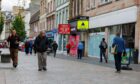 shoppers walk past 'To let' signs on Perth High Street