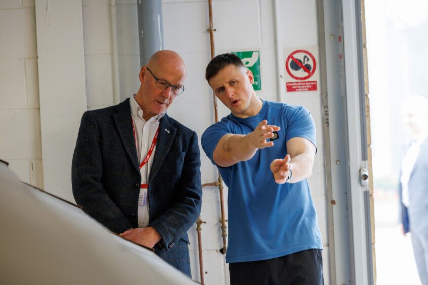 John Swinney MSP talking to Craig McFarlane, one of the men who took part in the project.