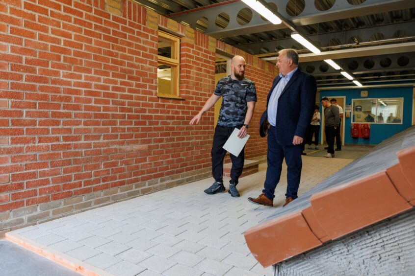 George Smart, one of the Perth Prison 'builders' walks Dave Barber, Operations Director for Robertson's Construction Tayside, around the project.