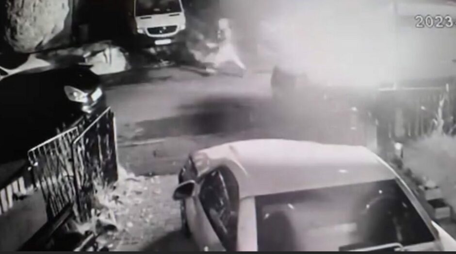 A CCTV image of a person fleeing moments after van engulfed in flames in Kelty
