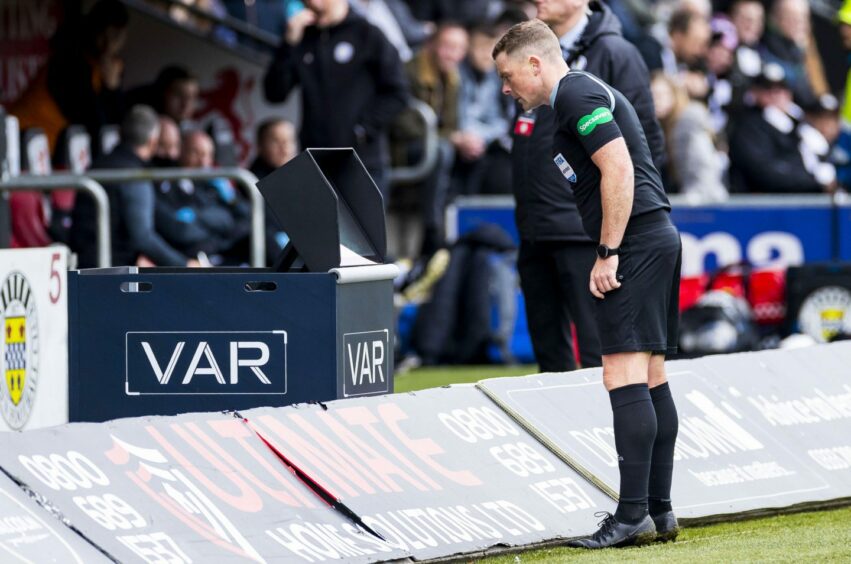 Referee John Beaton using VAR at St Mirren. Image: SNS