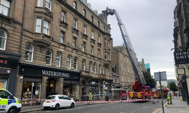 Firefighters using a height appliance to check the roof on Commercial Street, Dundee