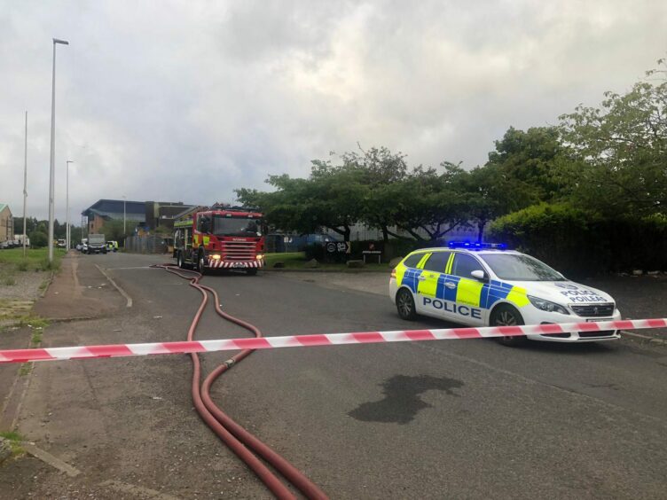 A cordon with police and firefighters at Wester Gourdie Industrial Estate