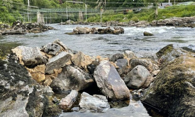 rocks joined with concrete in middle of River Tay at Grandtully in Perthshire.