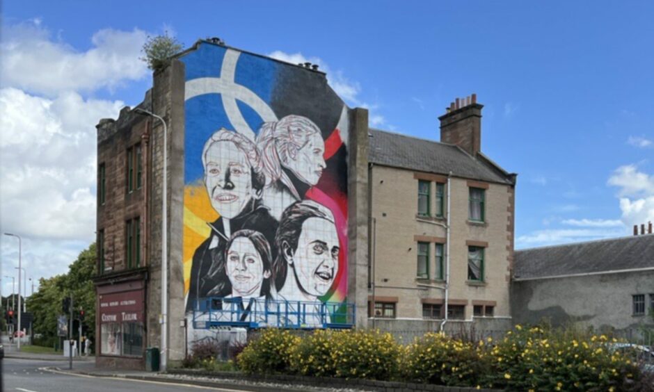 Mural of four-strong women's Olympic gold medal winning curling team on gable end in Perth.