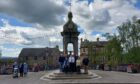 members of restoration group next to Murray Fountain in Crieff's James Square.
