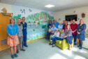 Patients, staff and visitors beside the new mural at Crieff Community Hospital.