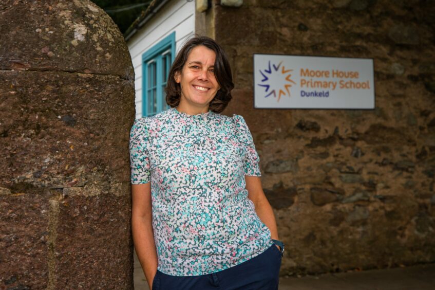 Primary teacher Pam Bicocchi leaning on a wall outside Moore House Primary School Dunkeld.