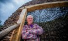 Scottish Crannog Centre director Mike Benson standing at the entrance to a large wooden structure at the museum's new base near Kenmore.