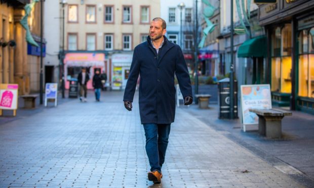 Iain Fenwick walking through Perth city centre