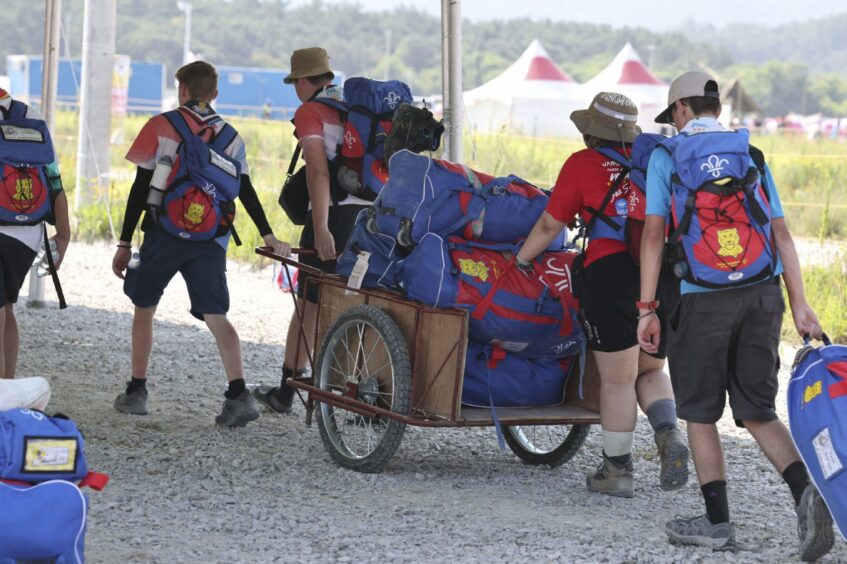 U.S. Scout members carry their bags to leave the World Scout Jamboree campsite in Buan, South Korea on Sunday.