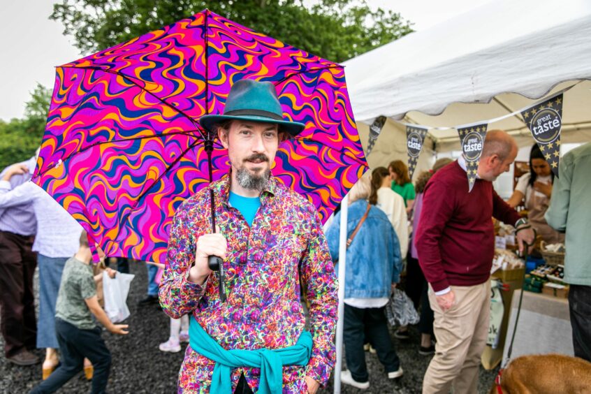 David Hart from Blairgowrie in colourful shirt and umbrella at the Barrie Box summer fair.