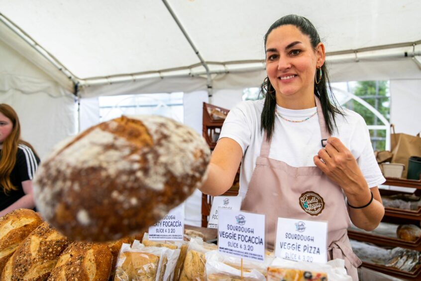 Francesca Polegato handing over a sourdough loaf at the Barrie Box summer fair