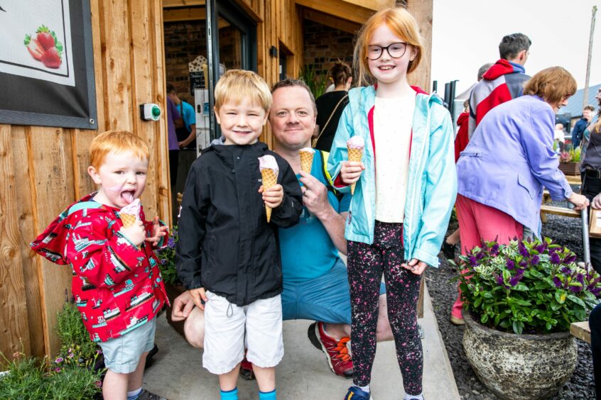 Stanley (3), George (6), Jamie (39) and Freya (8) Grewar holding ice creams.