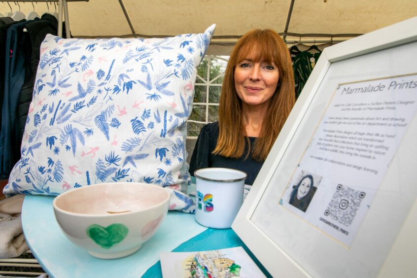 Cath Carruthers of Marmalade Prints with cushions and bowls.