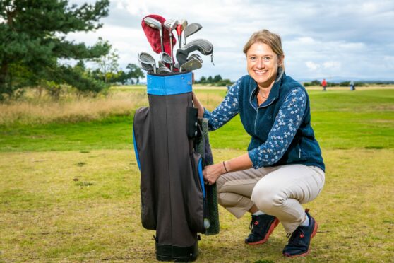 Image shows Sophie Mifsud with her Everyday Heirloom Grandma's golf bag and clubs. Sophie is crouching beside the bag and smiling broadly.