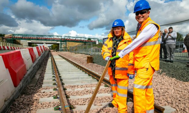 Transport minister Fiona Hyslop and Alex Hynes, managing director of Scotland's Railway, mark the completion of the track at Levenmouth Rail link
