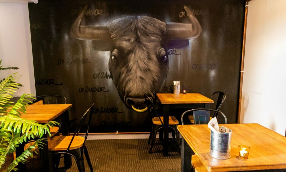 A graffiti painting of a black bull inside Ox & Anchor.