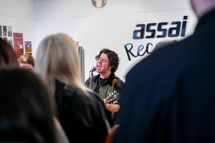 Kyle Falconer sings out to the crowd at Assai Records in Dundee.