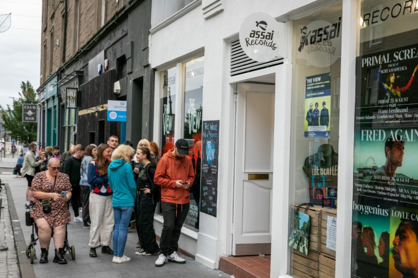 Fans line up outside Assai Records in Dundee.
