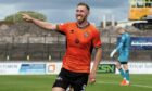 Louis Moult wheels away in delight after scoring for Dundee United