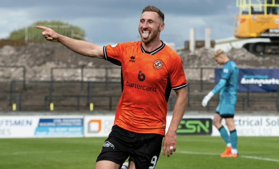 Louis Moult wheels away in delight after scoring for Dundee United 