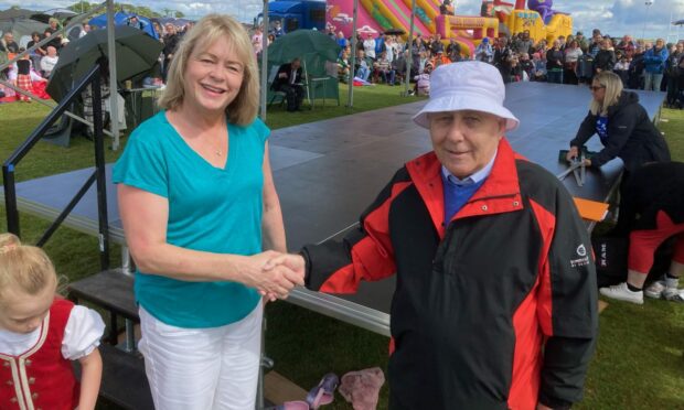 Frances Brocklebank, who sits on the Kinburn Trust, was thanked by Ian Grieve, of St Andrews Highland Games committee on Sunday July 30, for a donation which funded a new dancing stage for competitors. Image: Ted Brocklebank