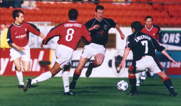 Brian Irvine takes on Rangers for Dundee in a clash taking place at Tannadice.