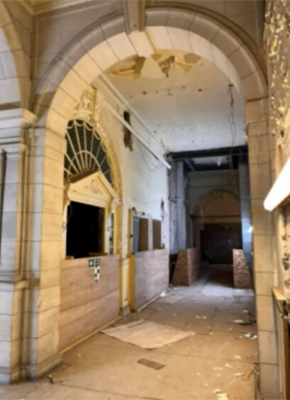 The entrance hall shows peeling plaster