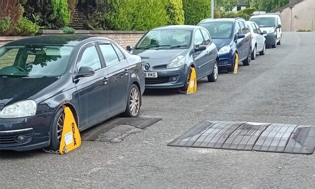 A row of cars on Service Road in Forfar were clamped. Image: Martin Gray.