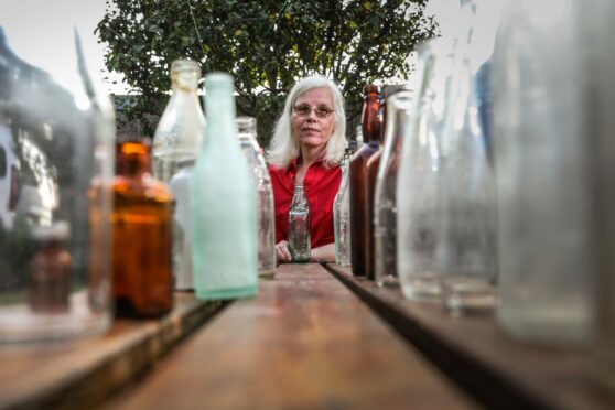 Seonaid McGurk of Monifieth Eco Force with some of her collection of old bottles.